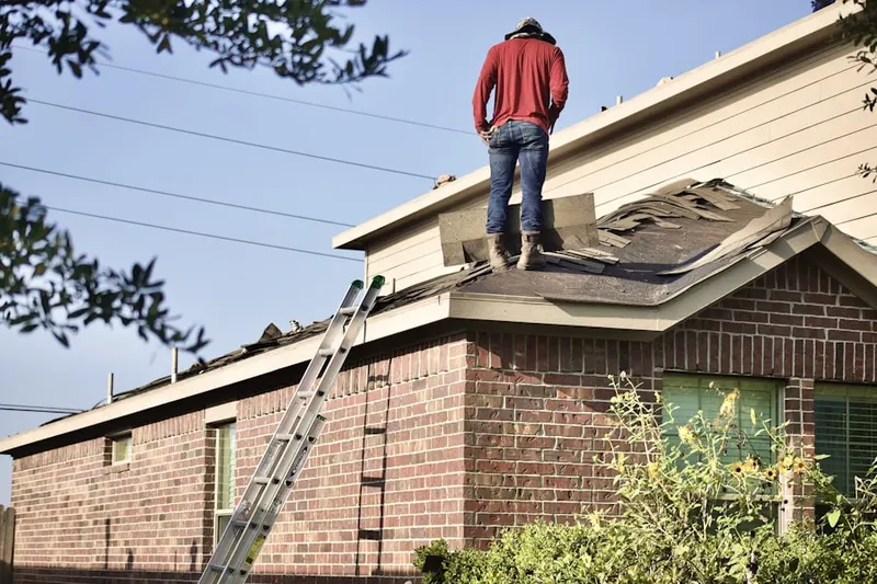 Professional roofer working on a residential roof in Estrella Mountain Ranch